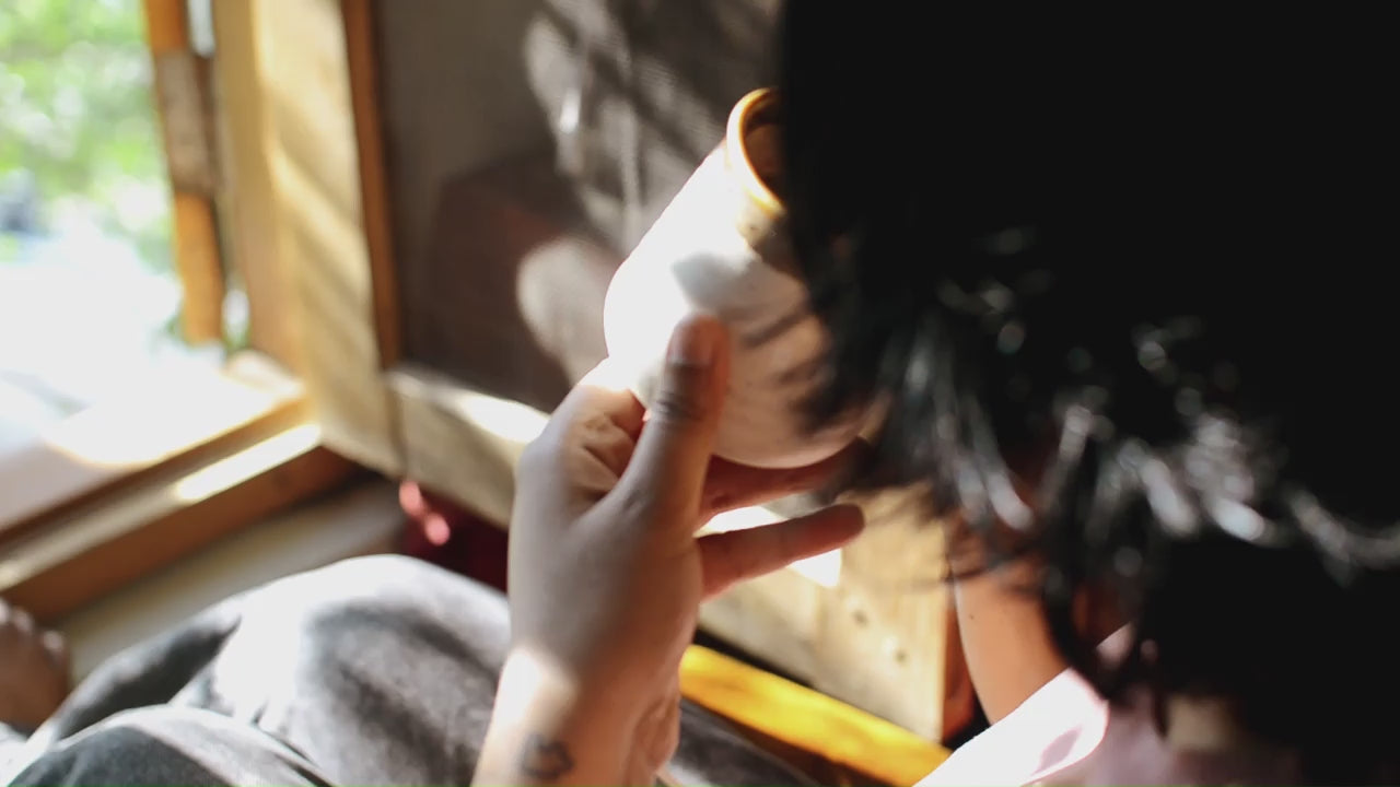 Load video: Reading a book quietly with a cup of cacao by the window overlooking the trees
